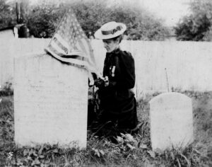 Mary Shellman placing a flag and flowers on the grave of a Union soldier in Westminster, c.1890 (Historical Society of Carroll County)